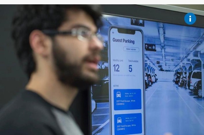 Farhad Keramati in profile beside a screen showing SmartONE guest parking on a phone interface, from a Toronto Star feature.